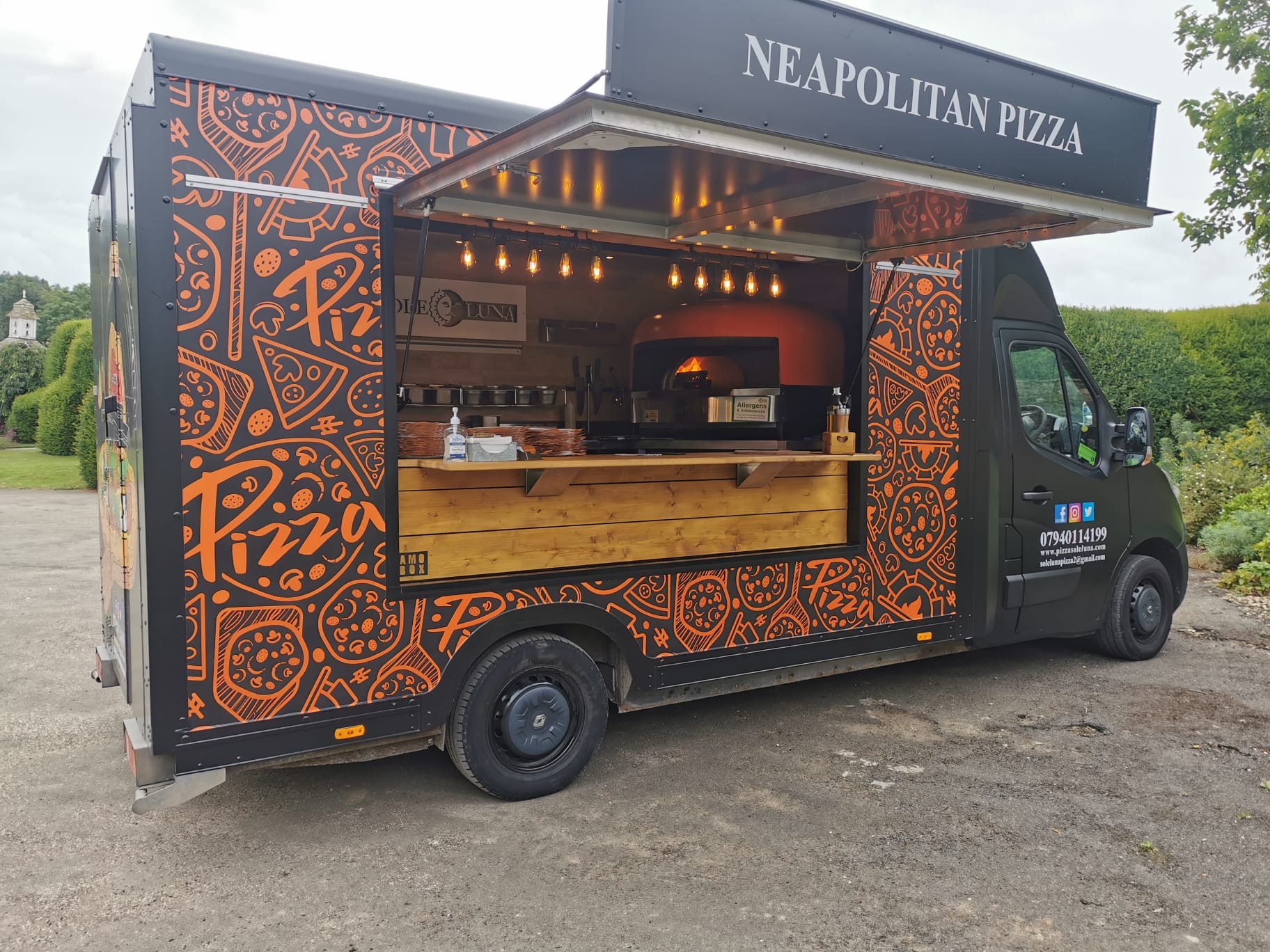 Neapolitan Pizza Van catering truck set up outdoors at a wedding venue