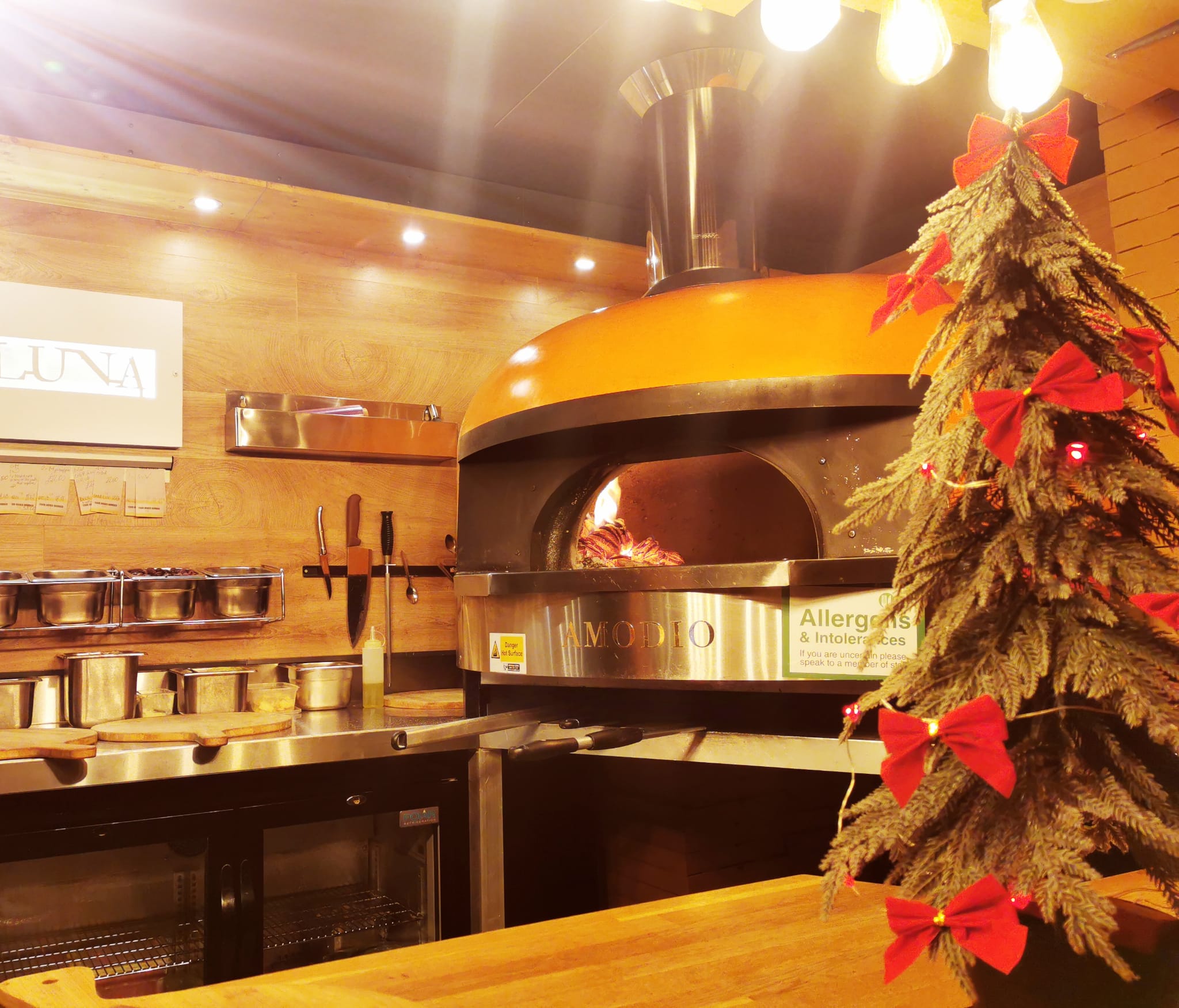Wood-fired pizza oven inside a mobile pizza catering setup